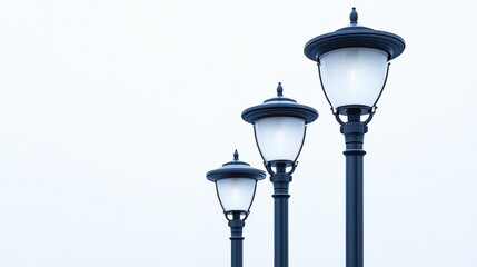 Poster - Three elegant street lamps lined up against a clear sky, enhancing urban aesthetics and ambiance