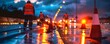 © AlirezA - Workers manage road construction at dusk with traffic cones and illuminated barriers on a wet surface