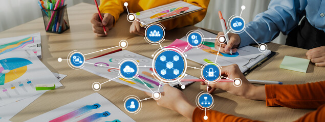 Poster - A group of diverse individuals collaborates at a table, engaging in data analysis and creative brainstorming while surrounded by colorful charts and diagrams. Amity