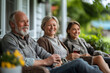 © Ala - Friends and family laugh together on a relaxing porch afternoon