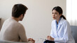 © Thunder - Young Asian doctor attentively listens and takes notes during a patient consultation in a clinical setting.
