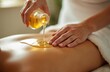 © Vadym - Beautician pours massage golden oil on client back in serene wellness spa. Touch, aromatherapy promote relaxation. Sensual skincare rejuvenation session. Essential natural oils for pampering body.
