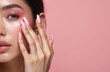 © Vadym - Close-up of woman face with pink makeup, manicure. Pink eyeshadow, glossy lips and nail polish. Model hand touches soft flawless skin. Beauty portrait on pastel background. Fashion style concept.