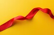 © MrHamster - A vibrant red ribbon elegantly curves against a bright yellow background