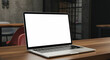 © Amir - A stylish, modern laptop with a white blank screen, set on a coworking space table with an industrial-style background. The shot is slightly angled for a dynamic and realistic look