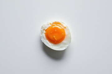 Poster - Vibrant yolk glistens against soft egg white on clean backdrop for food ingredient concept