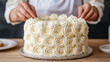 © praewpailyn - Close up of hands decorating homemade cake with creamy frosting, showcasing intricate designs and beautiful finish. Perfect for baking enthusiasts and dessert lovers
