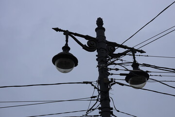 Poster - A telephone pole with multiple streetlights installed.