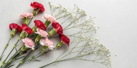 Aufkleber - A delicate arrangement of pink and red carnations, their petals gently unfurling, interwoven with delicate sprigs of white blossoms, creating a soft and romantic floral composition.