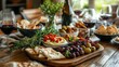 © Aisha - A traditional wooden table set with a platter of Mediterranean appetizers, including hummus, olives, and pita bread