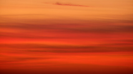 Wall Mural - Blurred sunset sky with orange and red gradient clouds. Nature background for design and print