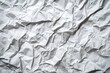 © vefimov - A collection of crumpled paper with creases and wrinkles, set against a gray background.