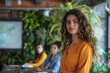 © AlirezA - Professional woman presenting in a vibrant workspace with plants and colleagues during a business meeting