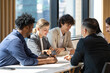 © Akarawut - Team of diversity business people are discussing over the new strategic strategy project on investment real estate while working in modern office building for new project and planning concept