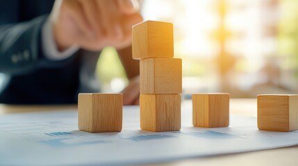 Poster - A businessperson builds a structure with wooden blocks, symbolizing strategy and growth in a professional environment.