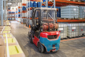 Poster - Old forklift inside warehouse. Storage area with barrels and loading equipment. Forklift without driver between warehouse racks. Warehouse interior with barrels. Dirty forklift with gas cylinder