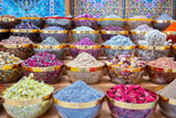 Traditional spices market. Pots and wooden tubs stand in row with colorful tea, spices, fruits, roots, flowers. Street bazaar. Dubai, UAE. 