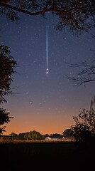 Wall Mural - stunning shooting star streaking across the night sky creating a magical moment in a dreamy cosmic l