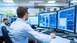 © AmStock - Focused Professional Analyzing Data on Multiple Computer Screens