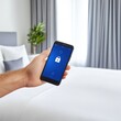 © WIrul - Individual holding a smartphone in hand with a focus on smart home security features for enhanced protection