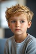 © Synthetica - A young boy with blonde hair and blue eyes is sitting in a chair