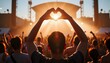 © Lightning - Person making heart shape with hands at a music festival during sunset