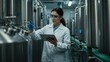 © Qbertstudio - Caucasian female scientist in lab coat using tablet in biotechnology facility Focus on research and innovation in STEM