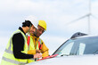 © Alberto - Wind turbine engineers working and using tablet near their car in a renewable energy power plant