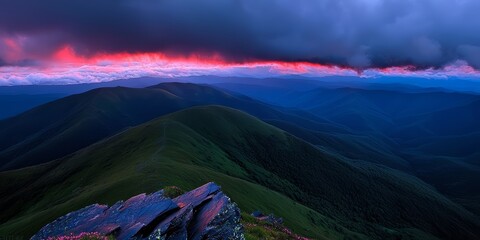 Poster - Beautiful mountain range with a pink and purple sky in the background. The mountains are covered in green trees and the sky is filled with clouds. The scene is serene and peaceful