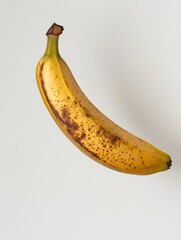 Leinwandbilder - Minimalist presentation of a ripe banana on a pastel background with soft lighting and balanced composition