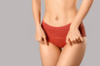 © Pixel-Shot - Young woman in panties on grey background
