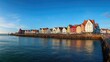 © Olena - Vibrant Shoreline: Iconic Colorful Houses on Helgoland Island by the Serene Waterfront