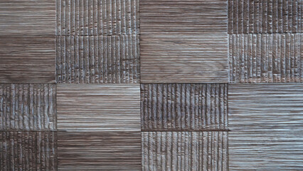 Poster - A wooden wall with a pattern of squares and stripes. The wall is made of wood and has a rustic feel