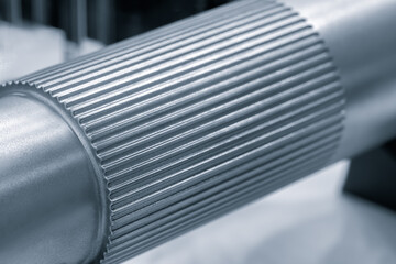 Poster - Metal shaft with many ridges on it. The ridges are very close together and the tube is very long