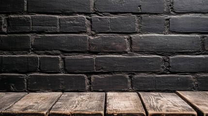 Aufkleber - An empty brown wooden table sits gracefully in front of a weathered black brick wall, ideal for intimate gatherings or artistic displays. The ambiance evokes warmth and creativity