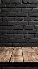 Aufkleber - A beautifully crafted brown wooden table stands empty against a textured black brick wall, inviting creativity and warmth in a cozy atmosphere ideal for gatherings or quiet moments