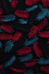 Poster - Textured Fabric Pattern with Red and Blue Leaves on Black Background