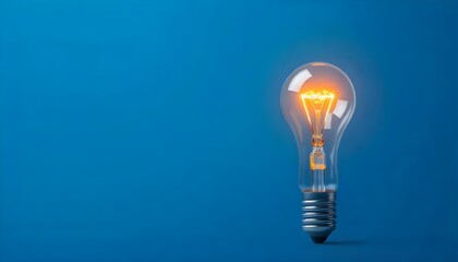 Poster - A single glowing light bulb standing out against a blue background