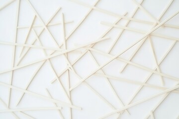 Poster - abstract wooden sticks arranged in a chaotic overlapping pattern on a white surface