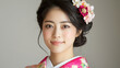 © Winyou - A woman with a pink flower headband is smiling
