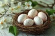 © Margarita - Rustic Still Life Bird's Nest with Speckled Eggs and Green Leaves on White Wooden Background
