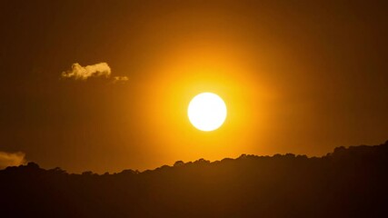 Wall Mural - timelapse of dramatic sunset with orange sky in a cloudy day.