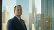 © Latthaphon - Corporate leader posing confidently in skyscraper office modern business environment professional portrait urban view