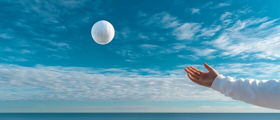 Wall Mural - a serene beach scene with a hand reaching out to a floating ball against a backdrop of blue sky and 