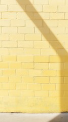 Aufkleber - Bright pale yellow brick wall with shadow creates a soothing backdrop for urban spaces and artistic displays