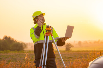 Fototapete - Engineer working on laptop in front of wind turbines for checking wind turbines of the field during beautiful sunset. Alternative energy concept.