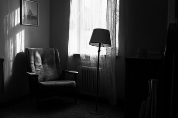 Aufkleber - A chair sitting next to a lamp in front of a window