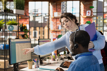 Poster - customer center manager teaching man how to log customer interactions in csm system on computer. cal