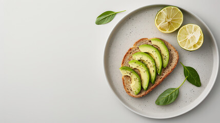 Poster - Avocado slices on artisanal bread with lime and basil leaves on minimalist plate