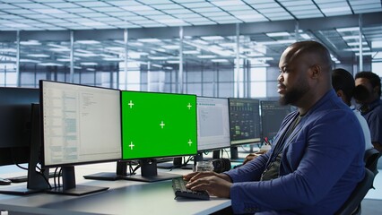 Poster - engineer using green screen computer in server room, developing disaster recovery plans ensuring min